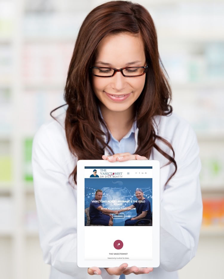Person holding a tablet that has loaded the home page of thevasectomist.com.au website