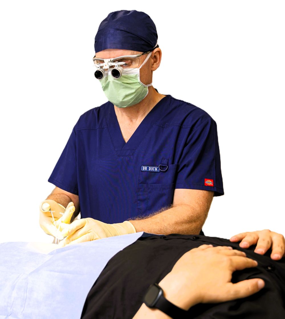 Dr Dick Beatty Working on a patient